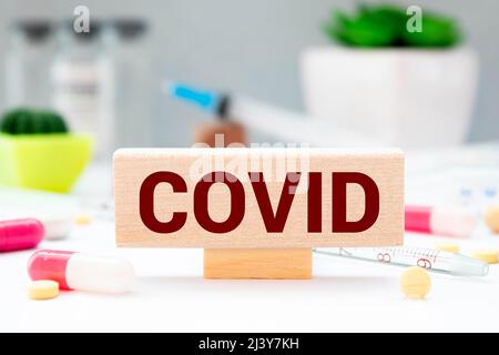 Test result of a Corona test. Hand turns a dice and changes the expression positive COVID19 to negative COVID19. Stock Photo