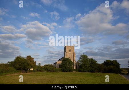 St Mary the Virgin Church with blue sky and fluffy white clouds, Wiveton, a small village in north Norfolk, East Anglia, England Stock Photo