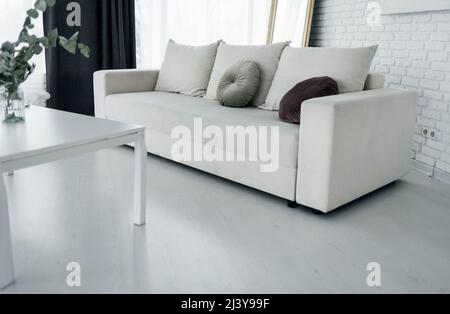 grey sofa with pillows living room interior. Real photo Stock Photo