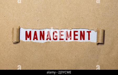 word Management on torn paper Stock Photo