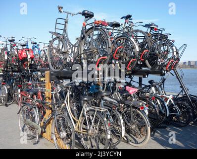 Bikes on a rack at Amsterdam ferry crossing River IJ. The Netherlands. Stock Photo