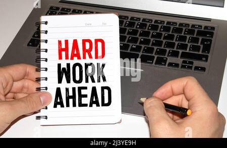 Word writing text HARD WORK AHEAD. Business concept for situation in which an employee works mainly from home Note paper taped to black computer scree Stock Photo