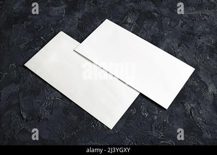 Blank paper envelopes on black plaster background. Template for your design. Stock Photo