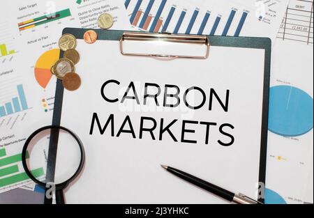 CARBON MARKETS. text on white paper near dollar bills Stock Photo
