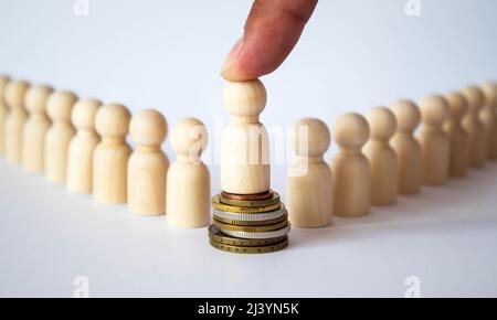 Small group of separated people seen from above represented anonymous with wooden figures on white background Stock Photo