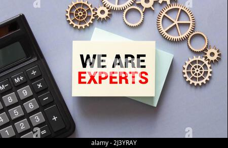 The business card with the text Ask The Expert is on the financial documents. Calculator and pen. Can be use as a financial and business concept Stock Photo