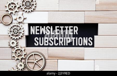 The words SUBSCRIBE NOW is written in a white notepad near a white cup of coffee on a light background Stock Photo