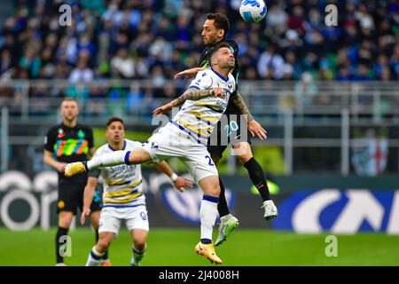 Milano, Italy. 09th, April 2022. Hakan Calhanoglu (20) of Inter and Daniel Bessa (24) of Verona seen in the Serie A match between Inter and Hellas Verona at Giuseppe Meazza in Milano. (Photo credit: Gonzales Photo - Tommaso Fimiano). Stock Photo