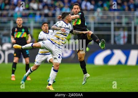 Milano, Italy. 09th, April 2022. Hakan Calhanoglu (20) of Inter and Daniel Bessa (24) of Verona seen in the Serie A match between Inter and Hellas Verona at Giuseppe Meazza in Milano. (Photo credit: Gonzales Photo - Tommaso Fimiano). Stock Photo