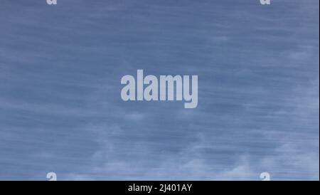 Bright blue sky with wispy white clouds. Stock Photo