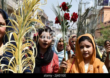 Lahore, Punjab, Pakistan. 10th Apr, 2022. Pakistani Catholic Christian pilgrims march during the Palm Sunday procession through the christian quarter Youhanabad in Lahore. Palm Sunday, a Christian feast that falls on the Sunday before Easter, marks the beginning of the Holy Week. Palm Sunday is a Christian moveable feast that falls on the Sunday before Easter and Christian holy day that marks the beginning of Holy Week and commemorates Jesus' triumphal entry into Jerusalem, an event mentioned in all four canonical Gospels. (Credit Image: © Rana Sajid Hussain/Pacific Press via ZUMA Press Wire) Stock Photo