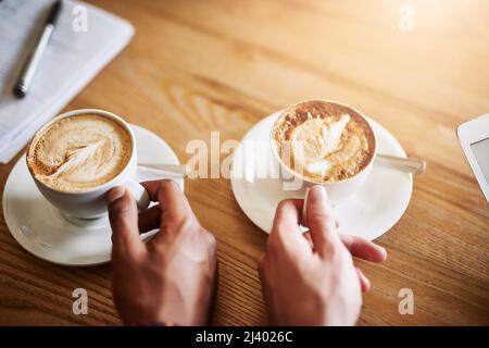 Coffee in good company. Shot of two unidentifiable men having coffee in a coffee shop. Stock Photo