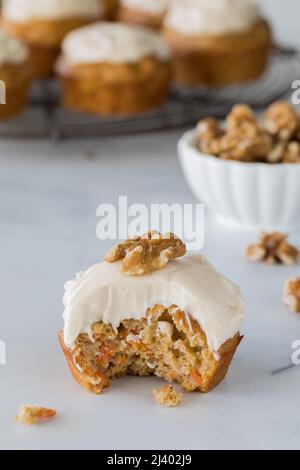 A close up of a delicious carrot cake muffin with a bite out. Stock Photo