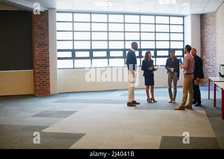 Gathered for a weekly management meeting. Shot of a group of businesspeople having a discussion in an office. Stock Photo