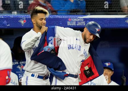 June 5, 2022, Toronto, ON, Canada: Toronto Blue Jaysâ€šÃ„Ã´ Lourdes Gurriel  Jr (13), left, puts the home run jacket on centre-fielder George Springer  (4) after Springer hit a solo home run against