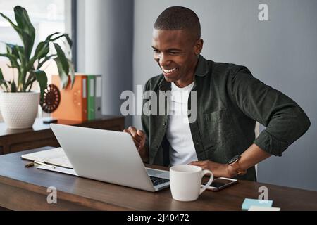 I shouldve been working from home all along. Shot of a young businessman using his laptop while working from home. Stock Photo