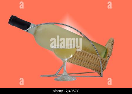 close-up of a glass and a bottle of white wine on an orange background Stock Photo