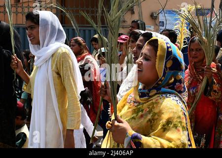 Lahore, Punjab, Pakistan. 10th Apr, 2022. Pakistani Catholic Christian pilgrims march during the Palm Sunday procession through the christian quarter Youhanabad in Lahore. Palm Sunday, a Christian feast that falls on the Sunday before Easter, marks the beginning of the Holy Week. Palm Sunday is a Christian moveable feast that falls on the Sunday before Easter and Christian holy day that marks the beginning of Holy Week and commemorates Jesus' triumphal entry into Jerusalem, an event mentioned in all four canonical Gospels. (Credit Image: © Rana Sajid Hussain/Pacific Press via ZUMA Press Wire) Stock Photo