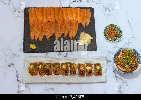 Salmon Sushi Rolls Platted On A White Marble Table. Image can be utilized editorially or commercially. Stock Photo
