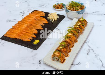 Salmon Sushi Rolls Platted On A White Marble Table. Image can be utilized editorially or commercially. Stock Photo
