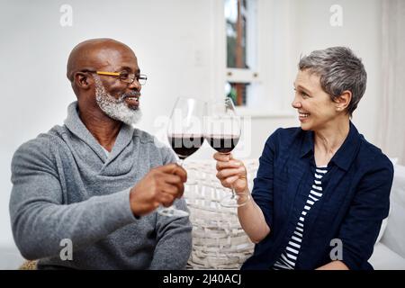 Were always celebrating our love for each other. Shot of an affectionate senior couple enjoying some wine together at home.