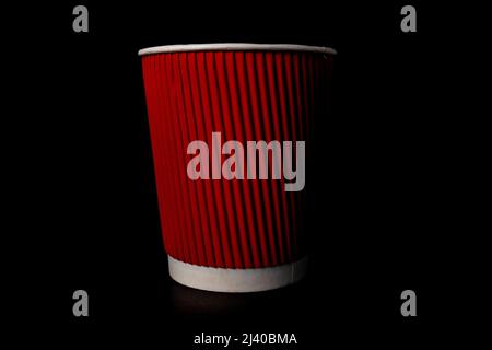 Red paper coffee cup isolated on black. Stock Photo
