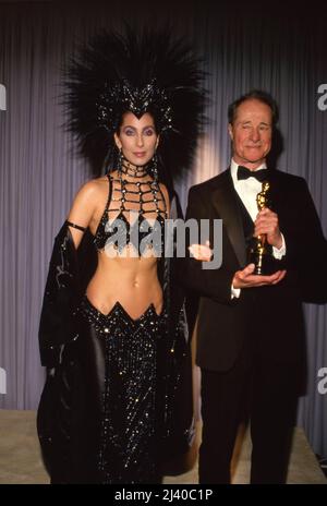 Don Ameche with Cher at the 58th Annual Academy Awards at Dorothy Chandler Pavillion in Los Angeles, California March 24, 1986 Credit: Ralph Dominguez/MediaPunch Stock Photo