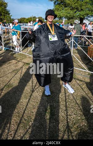 Austin, Texas, USA. 10 April, 2022. Runners dress in fancy costumes to raise money for charities. Over 15,000 people participated in the Capitol 10,000, a 10K run put on by the local daily paper, the Austin American Statesman. The first finishers to the Cap10K crossed the line in just over 30 minutes. Credit: Sidney Bruere/Alamy Live News Stock Photo