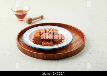 Yakgwa, Korean style honey cookie : Flour mixed with honey and sesame oil, pressed in a yakgwa pan (yakgwa mold), shallow-fried or deep-fried, dipped Stock Photo