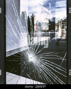 bullet hole in office window Stock Photo