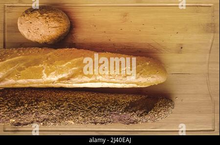 white and black breads on breadboard Stock Photo
