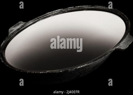 empty cast iron cauldron in dark Stock Photo