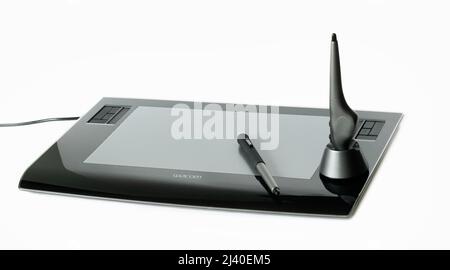 Wacom digital tablet and pens on white Stock Photo