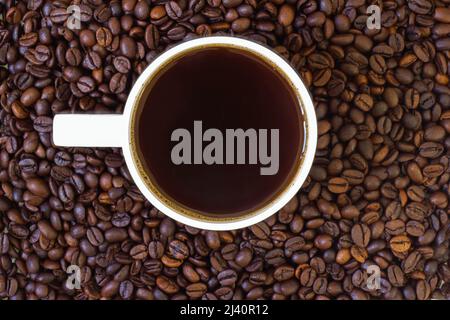 Ground coffee beans and freshly brewed hot filter coffee in the cup Stock Photo