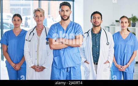 Dont judge each day by the harvest you reap. Shot of a group of doctors standing against a city background. Stock Photo