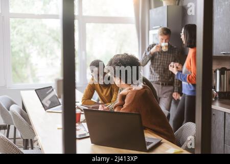 business team using a digital tablet to work with financial info Stock Photo