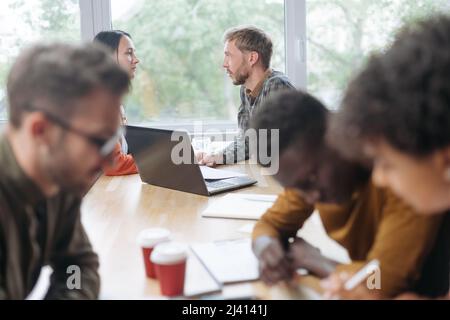 employees at their workplaces in the coworking center. Stock Photo