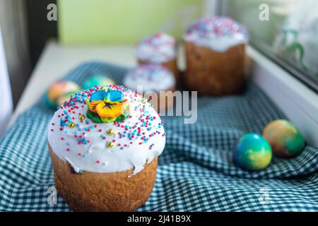 easter cake with willow twigs and blue , lilac eggs on a dark background. Stock Photo