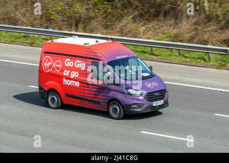 'Go Gig or go Home' play on words 2020 Virgin Media Ford Transit Custom 300Leader EBlue 1995cc 6 speed manual; driving on the M61 motorway UK Stock Photo