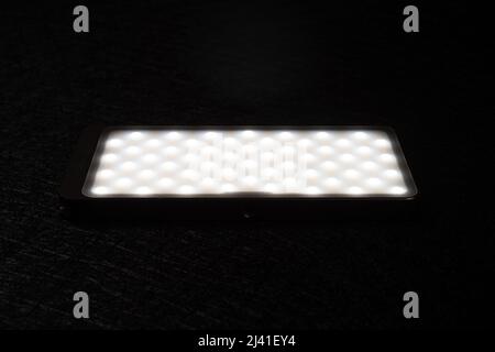 mini portable photography LED light on a dark background Stock Photo