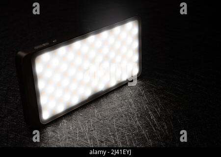 mini portable photography LED light on a dark background Stock Photo