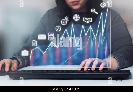 Woman on desk showing a growing virtual hologram stock on digital tablet. Stock market. Growth, progress and success concept. Stock Photo