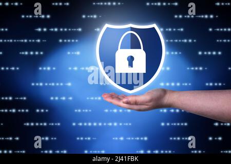 Woman hand showing digital security interface. Internet of things. Cybersecurity concept. Icon shield with a lock symbol. Protection against dangers. Stock Photo