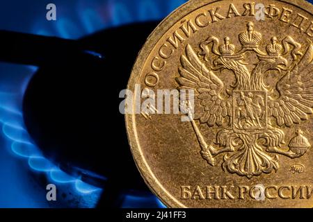 Russian ruble coin on the background of a gas burner. High quality photo Stock Photo