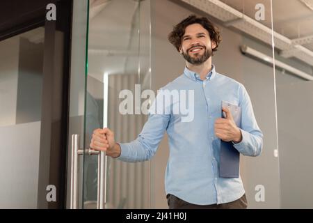 Portrait of smiling business man walking in office Stock Photo