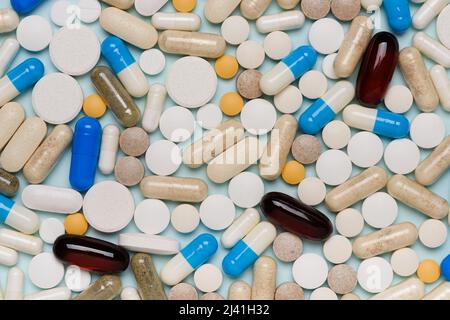 Pills texture background, different assorted drugs capsules on blue background top view. Stock Photo