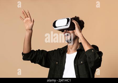 Joyful young bearded man having virtual reality glasses experience, closeup Stock Photo