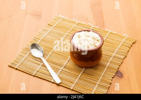 Rice pudding in a clay glass. Stock Photo