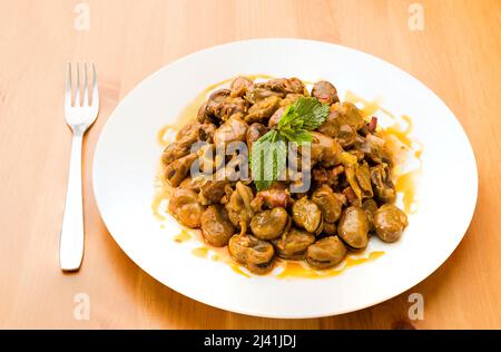 Typical Spanish food, tender broad beans with ham and mint. Stock Photo