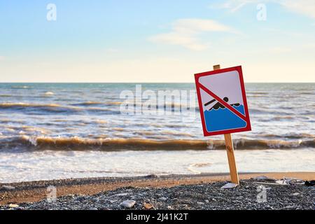 Warning no swimming sign with strong sea wave by the beach background Stock Photo